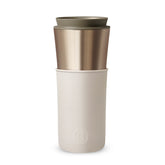 Two-toned travel mug with beige top and white bottom on a white background