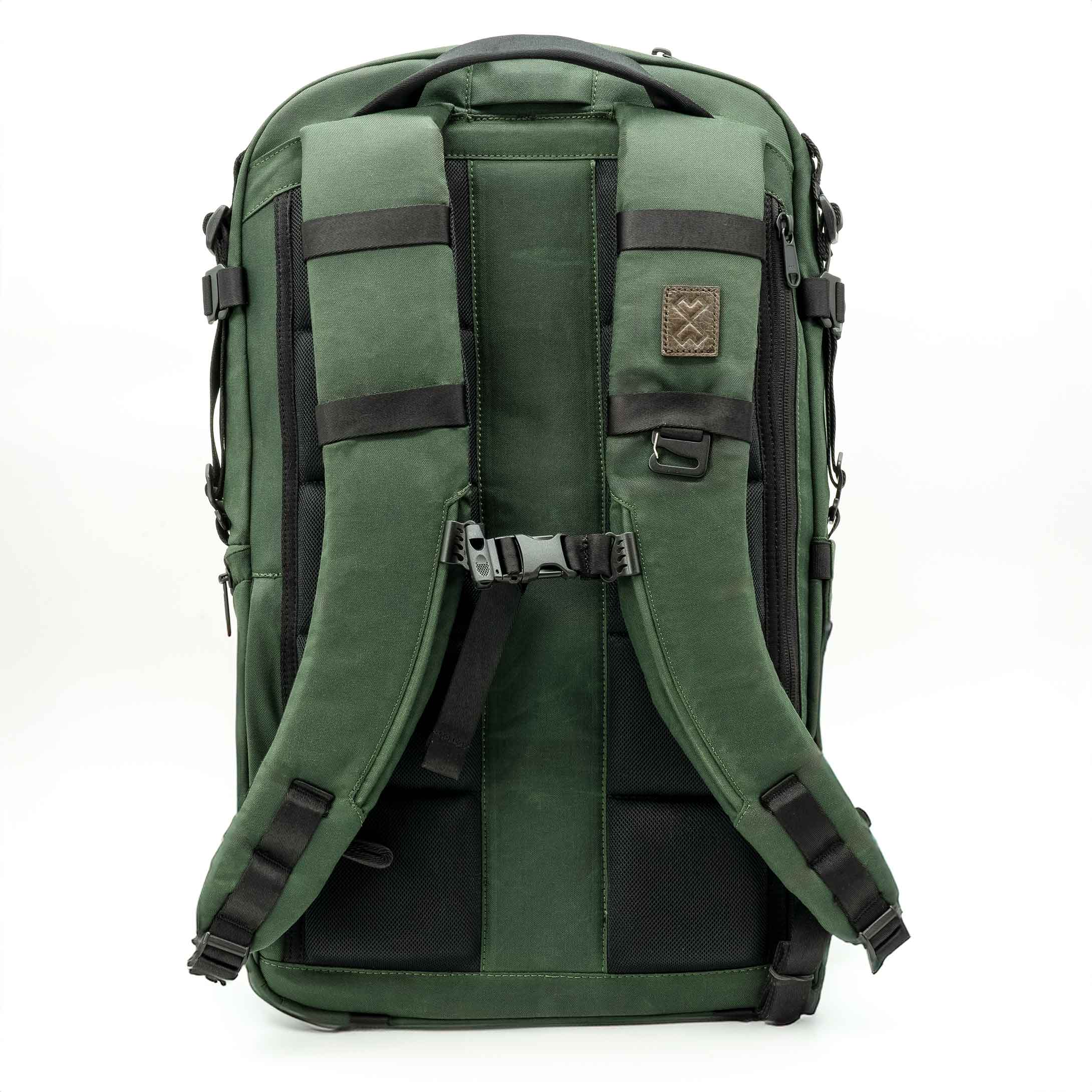Green backpack with black straps on a white background