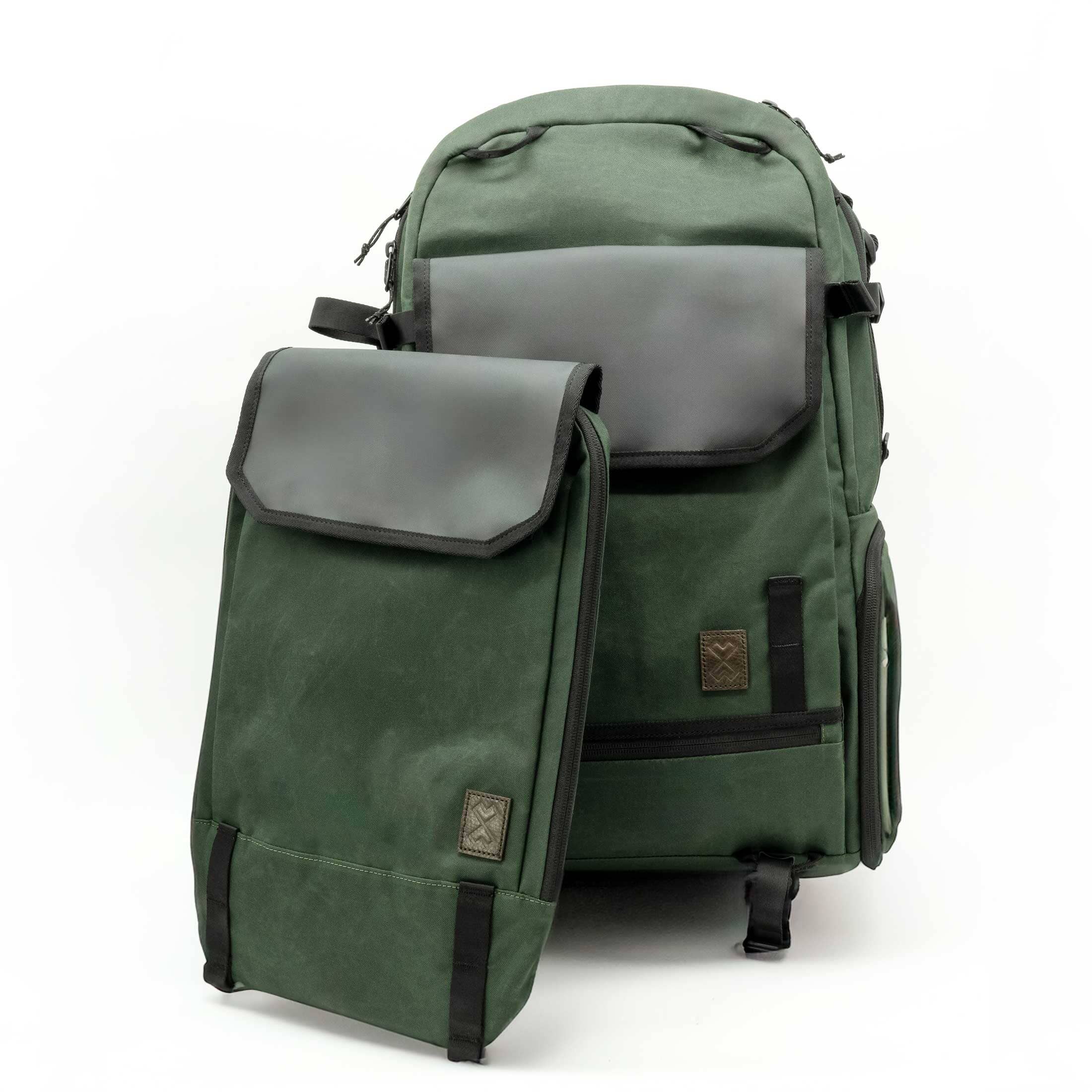 Green backpack with a smaller green pouch on a white background