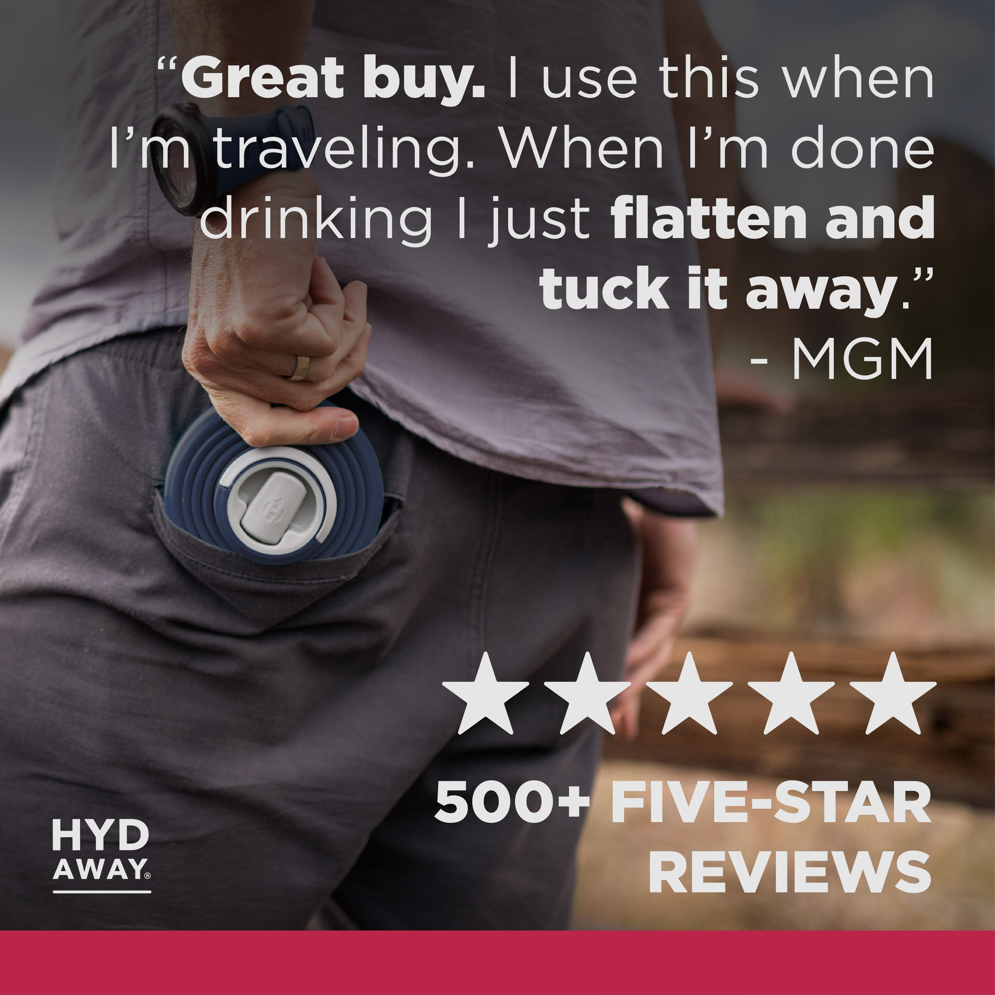 Person holding a blue travel mug with text and rating on a blurred background