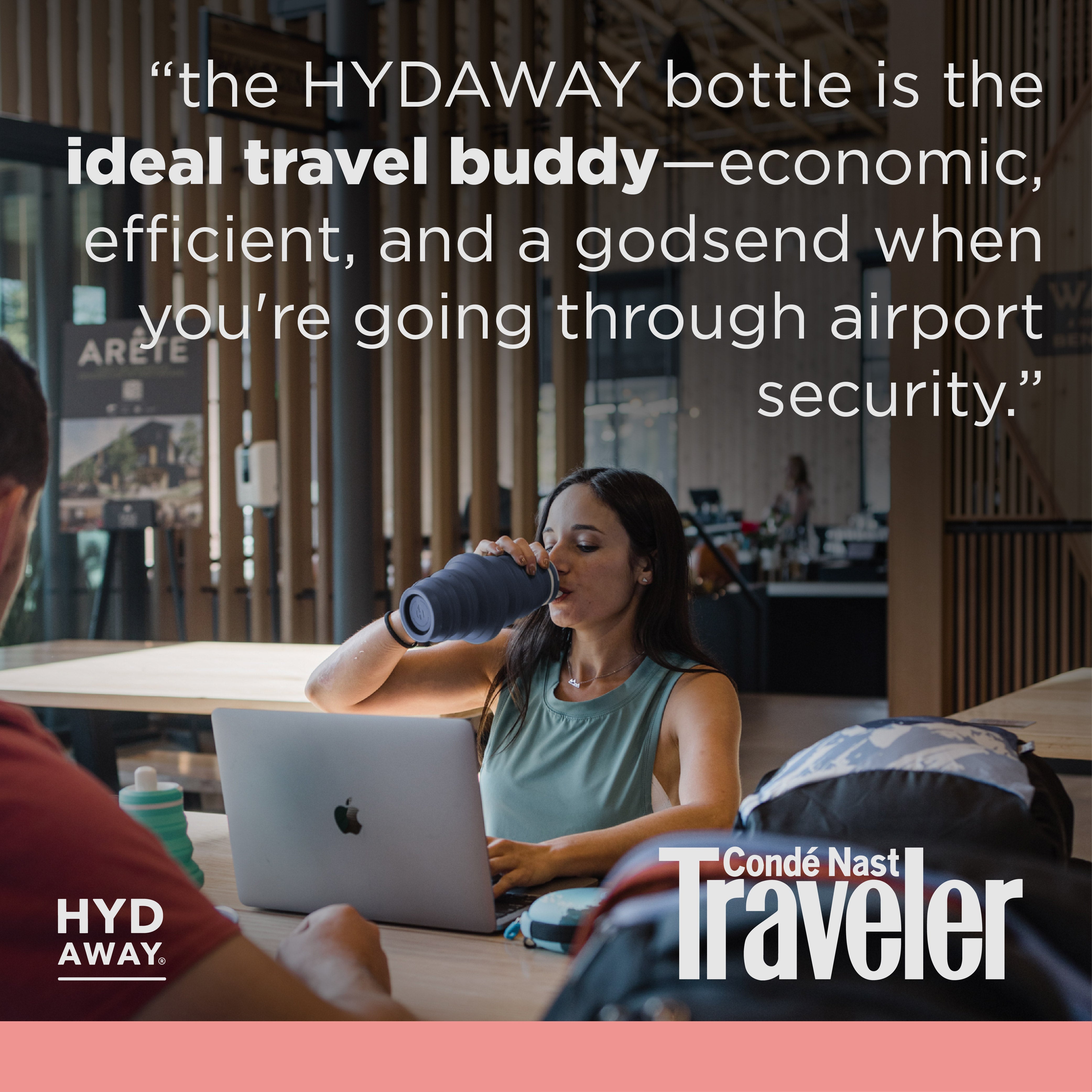Woman using a laptop with a bottle, sitting at a table in a modern indoor setting, with text about the HYDAWAY bottle.