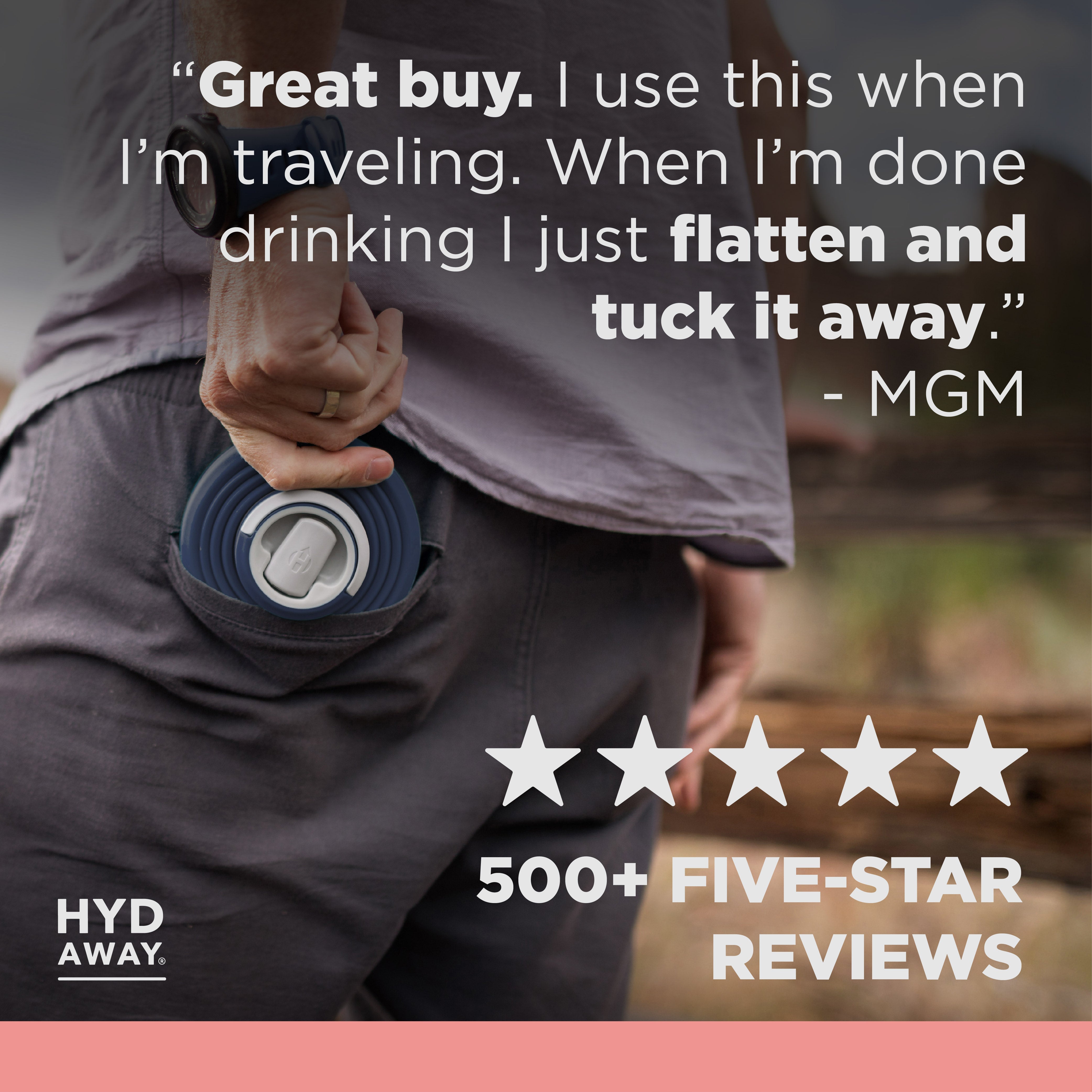 Person holding a blue travel mug with text and rating on a blurred background