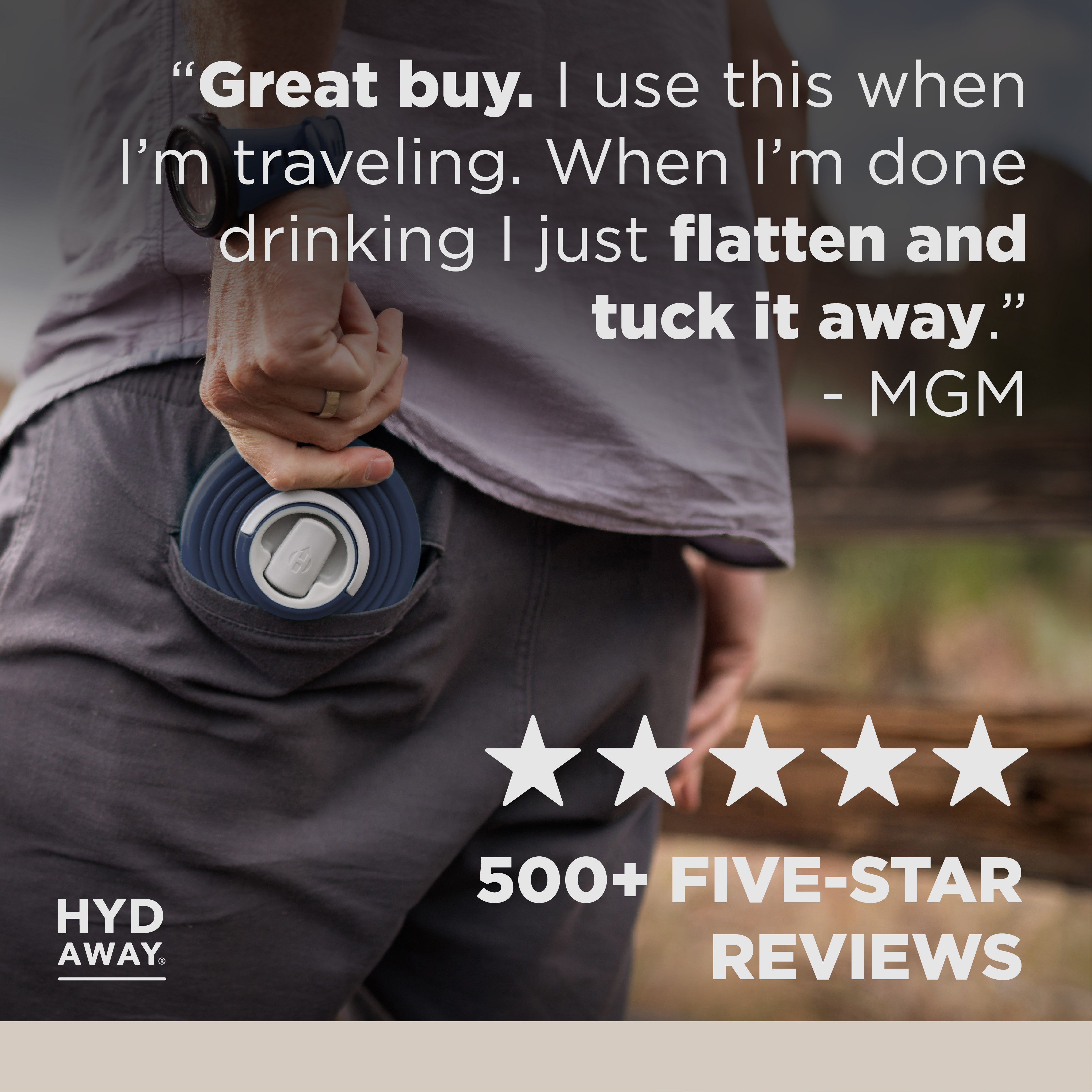 Person holding a blue travel mug with text and rating on a blurred background