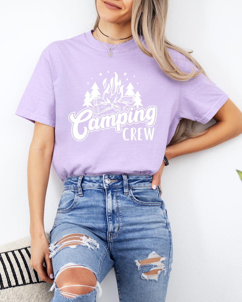Person wearing a purple 'MAMA' t-shirt and ripped jeans against a white background