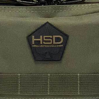 Close-up of a green tactical pouch with a patch labeled 'HSD' on a green background.