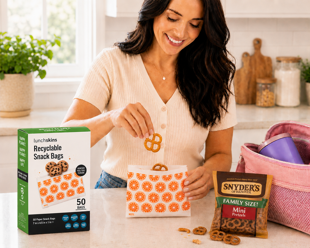 Woman in a kitchen packaging Snyder's of Hanover pretzels into a reusable snack bag.